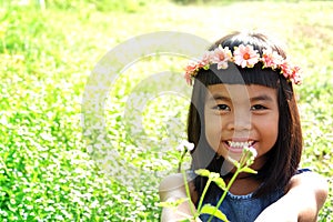 Happy girl hold flowers on nature blur background.