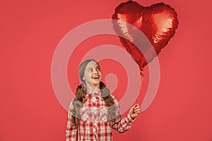 happy girl hold love heart balloon on red background