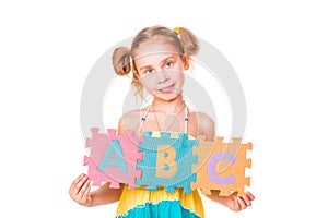 Happy girl holding alphabet letters ABC