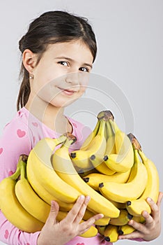 Happy girl holding banana