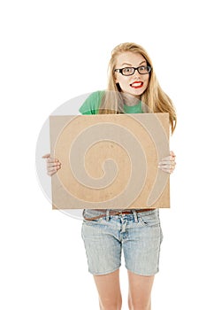 Happy girl holding empty wooden notice board.