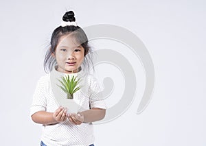 Happy girl holding  plant in her hand on white background