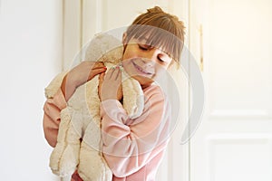 Happy girl, hug and love with teddy bear for comfort, soft toy or playful doll at home. Little child or kid with smile