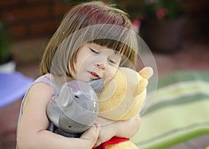 Happy girl hugging toys