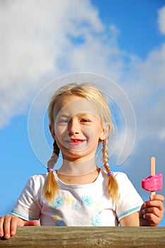 Happy girl with ice lolly photo