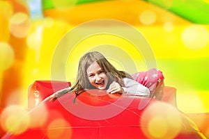 Happy Girl on Inflate Yellow Castle photo