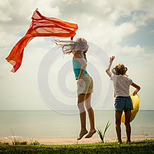 Happy girl jumping on the beach