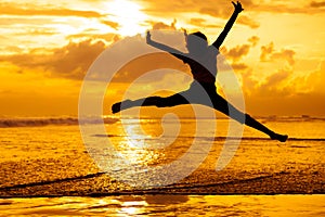 Happy girl jumping on the beach