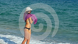 Happy girl Jumping and dancing on the beach, woman enjoys wind, freedom, vacation, summertime fun concept