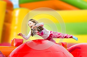 Happy Girl Jumping on the Playground Inflate Castle