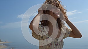 Happy girl jumping sea water in straw hat summer day close up. Woman have fun.
