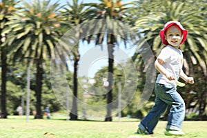 Happy girl kid running in park outside