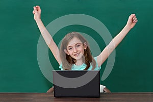 Happy Girl With Laptop In Classroom