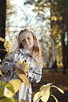 Happy girl in leaves autumn