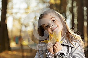 Happy girl in leaves autumn