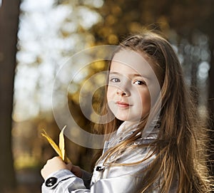 Happy girl in leaves autumn