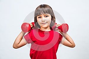 Happy girl lifting dumbbells for girl-boy fairness at sport photo