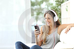 Happy girl listening to music from mobile phone