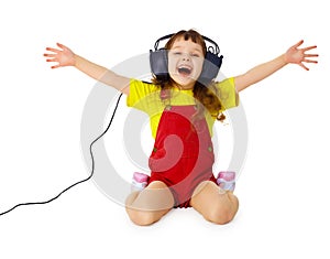 Happy girl listens to music with headphones