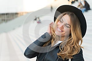 Happy girl with long blond hair, hairstyle, in paris, france. Girl in black hat smile outdoor, fashion. Beauty, look, makeup. Fash