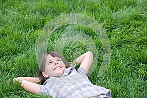Happy girl lying on the grass