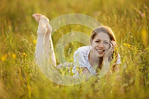 Happy girl lying in the grass