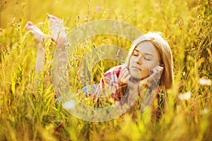 Happy girl lying in grass