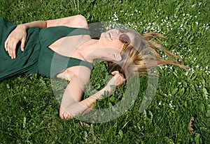 Happy girl lying on grass
