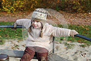 Happy girl on a merry-go-round