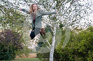 Happy girl in midair jump photo