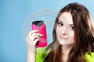 Happy girl with mobile phone in pink cover