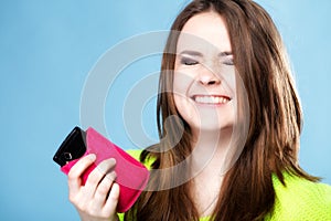 Happy girl with mobile phone in pink cover