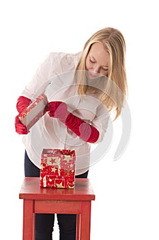 Happy girl opens a box with a gift