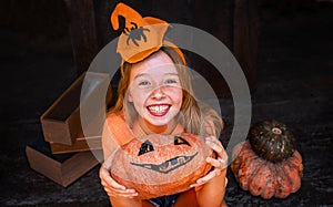 Happy girl with orange pumpkin
