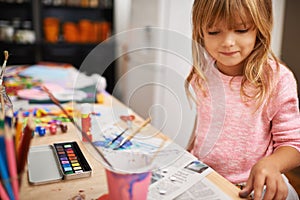 Happy girl, paint and drawing with color for creativity, learning or education at home. Young child with smile and