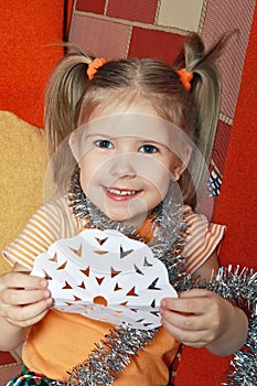 The happy girl with a paper snowflake