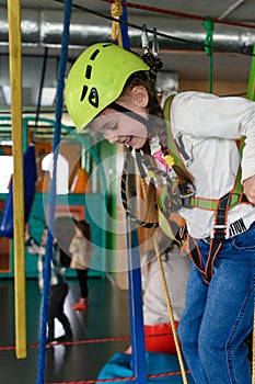 Happy girl passes the cableway, active recreation in the game room.