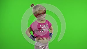 Happy girl in pink sportswear showing thumb up gesture isolated on chroma key background. Fitness