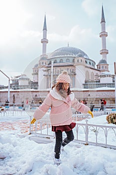 happy girl play with snow in taksim city square photo