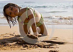 Happy girl playing on beach