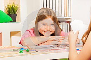 Happy girl playing cards with her opponent