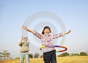 Happy girl playing hula hoops photo