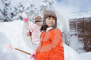 happy girl playing outside in the snow