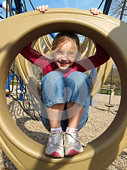 Happy girl playing at playground.