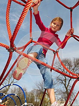 Happy girl playing at playground.