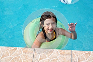 Happy girl playing in pool