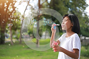 Happy girl playing with soap bubbles. Active child walking in the park. Family lifestyle. holiday kid concept