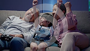 Happy girl playing video games with senior grandparents happily