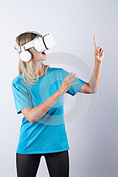 Happy girl pointing or spinning basketball while using VR glasses. Contraption.