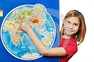 Happy girl points to place on world map